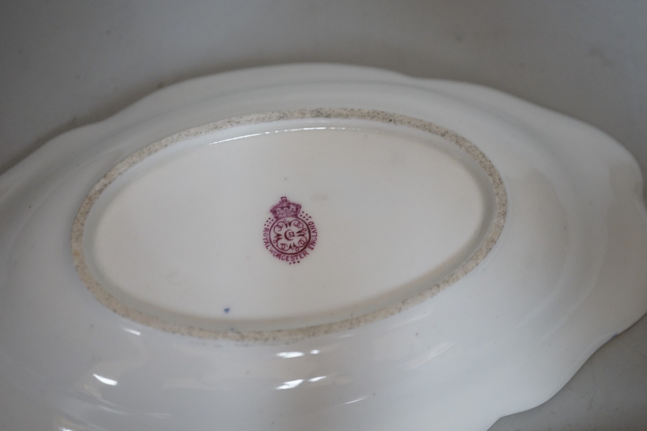 A pair of Royal Worcester blue ground floral painted dishes by E Phillips, signed date code for 1894, length 21cm